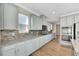 Gray kitchen cabinets, granite counters, and tile backsplash at 1192 Multiflora Loop, Lutz, FL 33558