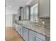 Gray kitchen cabinets, granite counters, and tile backsplash at 1192 Multiflora Loop, Lutz, FL 33558