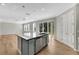 Modern kitchen with island, stainless steel appliances, and light gray cabinets at 1192 Multiflora Loop, Lutz, FL 33558