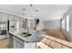 Kitchen island with granite countertops and a double sink at 1192 Multiflora Loop, Lutz, FL 33558