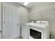 Laundry room with washer, dryer, and built-in shelving at 1192 Multiflora Loop, Lutz, FL 33558
