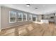 Bright living room with hardwood floors and view to kitchen at 1192 Multiflora Loop, Lutz, FL 33558