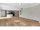 Open living room with hardwood floors and kitchen view at 1192 Multiflora Loop, Lutz, FL 33558