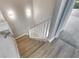 Modern stairs with light wood flooring and white railing at 1192 Multiflora Loop, Lutz, FL 33558