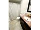 Bathroom with shower/tub combo, vanity, and tile floor at 1235 S Highland Ave # 2-308, Clearwater, FL 33756