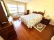 Bedroom with a double bed and hardwood floors at 1235 S Highland Ave # 2-308, Clearwater, FL 33756