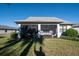 Screened patio with outdoor furniture, overlooking the backyard at 12457 Golden Sage Dr, Sarasota, FL 34238