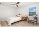 Bright bedroom with a queen bed, built-in desk, and ceiling fan at 12457 Golden Sage Dr, Sarasota, FL 34238