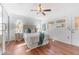 Bright bedroom with wood floors, mirrored closet doors, and access to the exterior at 1534 W Del Webb Blvd, Sun City Center, FL 33573