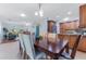 Bright dining area with a wood table and chairs, open to the living area at 1534 W Del Webb Blvd, Sun City Center, FL 33573