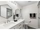 Modern bathroom with double vanity, large shower, and hexagon mirrors at 22 Turnstone Dr, Safety Harbor, FL 34695