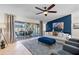 Spacious living room with blue accent wall and sliding glass doors to the pool area at 22 Turnstone Dr, Safety Harbor, FL 34695