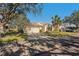 Exterior of a villa, showcasing a two-car garage and landscaping at 2217 Brookfield Greens Cir, Sun City Center, FL 33573