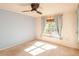 Bedroom with two windows, ceiling fan, and light blue walls at 330 Promenade Dr # 207, Dunedin, FL 34698