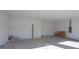 Unfinished two-car garage with concrete floor and ample space at 3430 Sarto Ln, Rotonda West, FL 33947