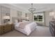 Bright main bedroom with a king-size bed, water view, and neutral decor at 3457 Timber Crossing Ave, Brandon, FL 33511