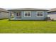 Expansive backyard with a well-manicured lawn, providing a serene outdoor space at 3952 Big Sky Dr, Spring Hill, FL 34604