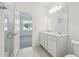 Elegant bathroom with double sinks, marble countertop, glass shower, and tile flooring, for a spa-like experience at 3952 Big Sky Dr, Spring Hill, FL 34604