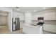 Modern kitchen with stainless steel appliances, white cabinets, and a central island, perfect for cooking and entertaining at 3952 Big Sky Dr, Spring Hill, FL 34604
