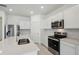 Bright kitchen with white cabinetry, stainless steel appliances, and center island at 3952 Big Sky Dr, Spring Hill, FL 34604
