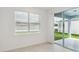 Bright living area with tile floors, sliding glass doors to patio, and view of the backyard at 3952 Big Sky Dr, Spring Hill, FL 34604