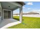 Covered patio overlooking a lush, green lawn, perfect for outdoor relaxation and entertainment at 3952 Big Sky Dr, Spring Hill, FL 34604