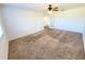 Spacious bedroom with carpet, ceiling fan, and French doors at 4027 Harbor Lake Dr, Lutz, FL 33558