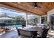 Covered patio with outdoor dining and a view of the pool at 4324 Auston Way, Palm Harbor, FL 34685