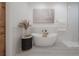 Relaxing bathroom with freestanding tub, modern fixtures, and large art at 6207 Barton Rd, Plant City, FL 33565