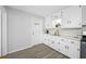 Bright white kitchen features updated countertops and appliances at 7302 N Highland Ave, Tampa, FL 33604