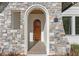 Elegant front entry with arched stone detail and a rich wood door at 809 W Amelia Ave, Tampa, FL 33602