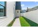 Side yard with walkway, landscaping, and white fence at 809 W Amelia Ave, Tampa, FL 33602