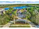 Luxury estate home with a lake view, lush landscaping, and a large backyard at 8376 Catamaran Cir, Lakewood Ranch, FL 34202