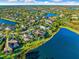 Aerial view of a luxury home by the lake at 8376 Catamaran Cir, Lakewood Ranch, FL 34202