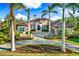 Luxury home with lake view, beautifully landscaped grounds, and a three-car garage at 8376 Catamaran Cir, Lakewood Ranch, FL 34202