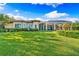 Large grassy backyard with home and pool view at 8376 Catamaran Cir, Lakewood Ranch, FL 34202