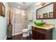 Elegant bathroom with glass shower, pebble tile accents, and a unique sink at 8376 Catamaran Cir, Lakewood Ranch, FL 34202