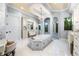 Large bathroom with double vanities, a soaking tub, and a walk-in shower at 8376 Catamaran Cir, Lakewood Ranch, FL 34202