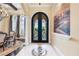 Elegant entryway with arched double doors, tile flooring, and a calming mural at 8376 Catamaran Cir, Lakewood Ranch, FL 34202