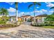 Beautiful home with three car garage, palm trees, and a large driveway at 8376 Catamaran Cir, Lakewood Ranch, FL 34202