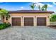 Three-car garage with dark brown doors and decorative hardware at 8376 Catamaran Cir, Lakewood Ranch, FL 34202