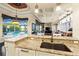 Kitchen with granite countertop, sink, and views to the pool and living room at 8376 Catamaran Cir, Lakewood Ranch, FL 34202
