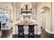 Island kitchen with granite countertops, custom cabinetry, and breakfast bar at 8376 Catamaran Cir, Lakewood Ranch, FL 34202