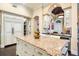 Large kitchen island with granite countertop, white cabinets, and pantry at 8376 Catamaran Cir, Lakewood Ranch, FL 34202