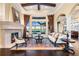 Living area with a fireplace, comfy seating, and large windows with water views at 8376 Catamaran Cir, Lakewood Ranch, FL 34202