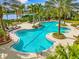 Large kidney-shaped pool with plenty of lounge chairs at 8376 Catamaran Cir, Lakewood Ranch, FL 34202