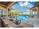 Luxury pool and spa with covered patio and tranquil lake views at 8376 Catamaran Cir, Lakewood Ranch, FL 34202