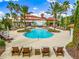 Freeform pool with plenty of lounge chairs and umbrellas at 8376 Catamaran Cir, Lakewood Ranch, FL 34202