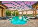 Enclosed pool and spa area with a relaxing view at sunset at 8376 Catamaran Cir, Lakewood Ranch, FL 34202