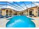 Resort-style pool with covered patio and lounge chairs at 8376 Catamaran Cir, Lakewood Ranch, FL 34202